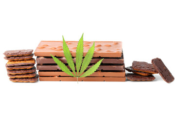 Edible medical marijuana food chocolate bars and chocolate cookies with green hemp leaf isolated on white background. Cannabis chocolates CBD