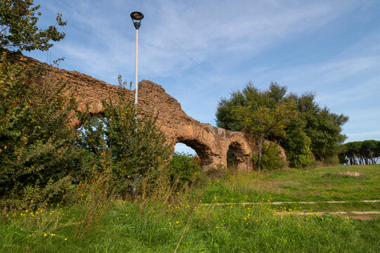 Alexandrian Aqueduct, the last of the great Roman aqueducts, built by the Emperor Alexander Severus. Detail of the arches and bricks on a sunny day and blue sky in the park, centocelle area. Rome