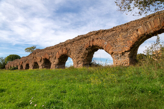 Alexandrian Aqueduct, the last of the great Roman aqueducts, built by the Emperor Alexander Severus. Detail of the arches and bricks on a sunny day and blue sky in the park, centocelle area. Rome.