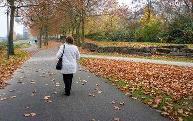 Fototapeta premium Mature sad woman walking in the old Park.
