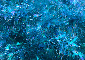 Abstract background with shiny tinsel Close up photo  Blue sparkle decorative frippery Christmas backdrop