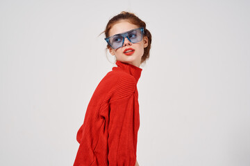 woman in red sweater jeans blue glasses side view