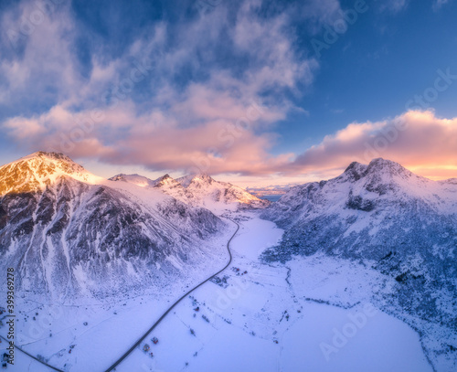 Beautiful Snowy Mountains In Winter At Sunset Aerial View Lofoten Islands Norway Colorful Landscape With Road Rocks In Snow Houses And Blue Sky With Sunlight And Pink Clouds Top View Nature Wall Beautiful Snowy Mountains In Winter At Sunset Aerial View Lofoten Islands Norway Colorful Landscape With Road Rocks In Snow Houses And Blue Sky With Sunlight And Pink Clouds Top View Nature Wall
