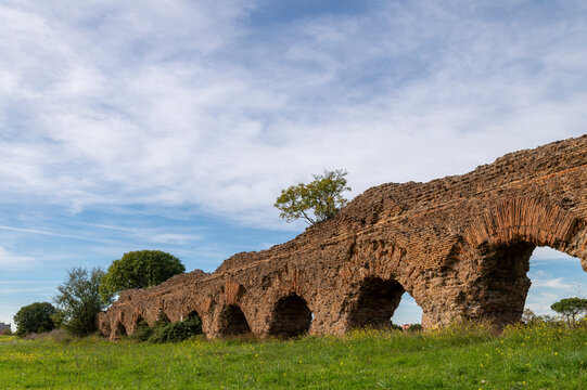 Alexandrian Aqueduct, the last of the great Roman aqueducts, built by the Emperor Alexander Severus. Detail of the arches and bricks on a sunny day and blue sky in the park, centocelle area. Rome.