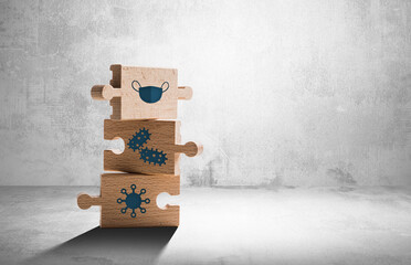 Wooden puzzle with icons of mask, virus, bacteria. Concept of protection against germs, disease...
