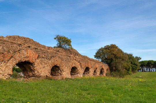 Alexandrian Aqueduct, the last of the great Roman aqueducts, built by the Emperor Alexander Severus. Detail of the arches and bricks on a sunny day and blue sky in the park, centocelle area. Rome.