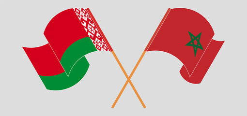 Crossed and waving flags of Belarus and Morocco