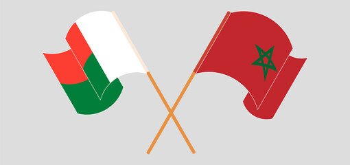 Crossed and waving flags of Madagascar and Morocco