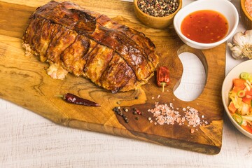 Baked minced meat with chili spices and sausage. Making classic meatloaf with ground beef. Tasty baked turkey meatloaf with bacon on wooden board.