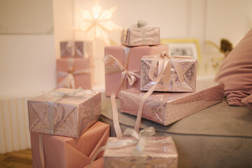 Close-up of beautiful present for Christmas. Beautiful Christmas gift boxes on floor near fir tree in room