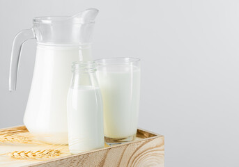 A jug and bottle of  fresh milk glass on wooden crate box..Raw milk is high in calcium and protein to drink for all ages..Milk consumption nutritious and healthy dairy products concept.