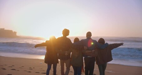 Friends hugging and walking towards the sea at the beach - Powered by Adobe