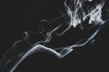 abstract smoke on a black background floats in the air