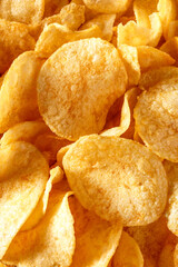 Potato chips or crisps .Potato chips texture background flat overhead view.concept of fast food and snacks. Food background.