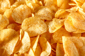 Potato chips or crisps .Potato chips texture background flat overhead view.concept of fast food and snacks. Food background.