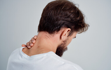 man touches his neck with his hand injury pain osteochondrosis problems with the spine