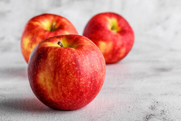  red apples on blackboard or chalkboard background. Bright fruit composition. Close-up on a gray background.