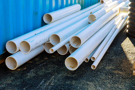 Pallets of white sewer pipes at construction for drainage system