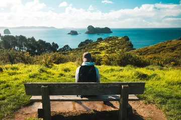 Printed kitchen splashbacks Cathedral Cove Young man sitting on a beach over looking Cathedral Cove