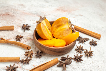 a bowl of palm with star anises and cinnamon sticks around it on the white marble ground