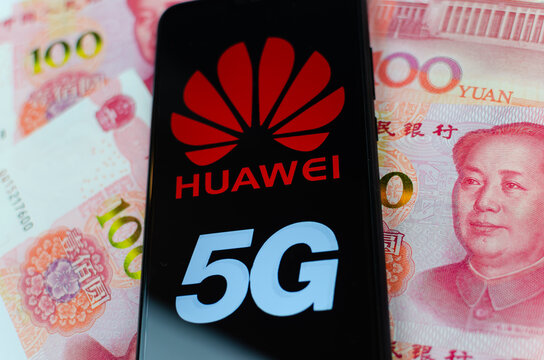 Concept photo for 5G network in China. Huawei 5G logo on a smartphone which is placed on the 100 yuan banknotes. Shallow depth of field.
