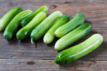 Fresh young cucumbers on wooden table
