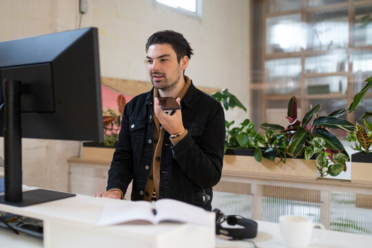Startup business owner talking on phone at desk