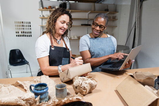 Coworkers of ceramics startup packing online orders