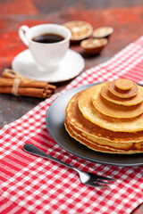 Tasty breakfast with pancakes a cup of tea and cinnamon lime vertical view stock image