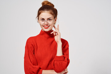 emotional woman in red sweater glasses on face bright makeup lips model