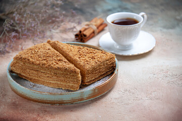 front view yummy honey cake with cup of tea on light background sweet biscuit cakes