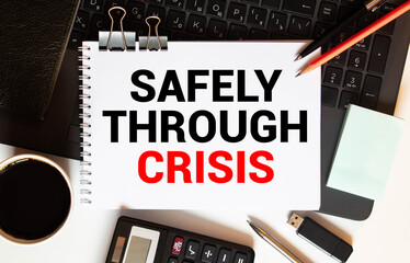 magnifier and paper with documents and SAFELY THROUGH CRISIS.