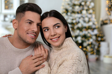 Fototapeta premium Happy couple in festively decorated room. Christmas celebration