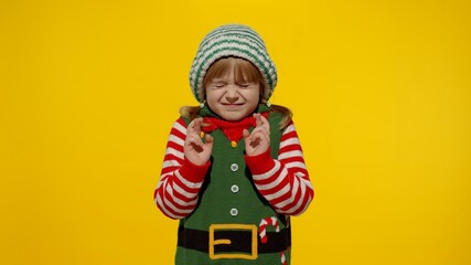 Shy smiling child. Christmas wish concept. Little fun blonde kid teen teenager girl in Christmas...
