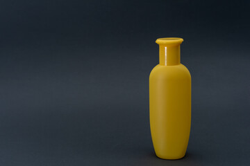 yellow bottle of liquid on gray background