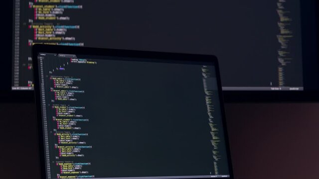 Real Javascript code. Front end web development. Java script JS code on laptop screen. Web design concept.