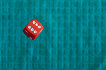 red dice floating on a turquoise background