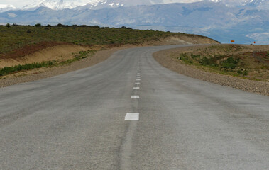 asphalt mountain road in the foreground with background landscape, no one