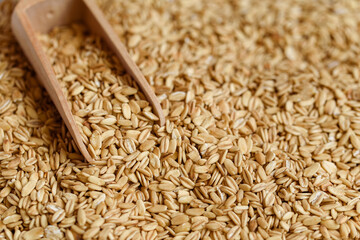 Oat cereal in wooden spoo on stone table. concept of vegetarian diet eating, dieting, sport and...