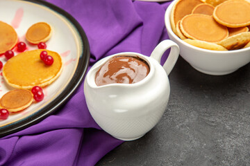 front view delicious little pancakes with cookies on a dark background milk dessert sweet