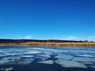 Ice floes float on the river. Thaw at the end of winter