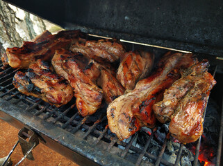 Smoky barbecue on the grill outside. The meaty taste of spring