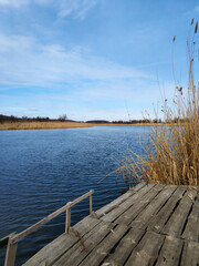 Obraz premium Quiet fishing spot by the river. View of the river from the bank