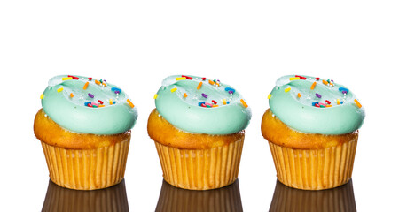Three colorful cupcakes isolated in a white background.
