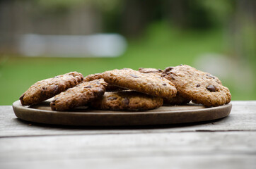 oatmeal cookies on wood with defocused natural background