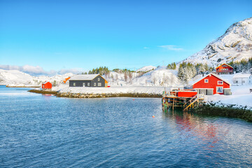 Traditional Norwegian red wooden houses on the shore of  Sundstraumen strait