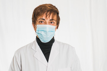 Doctor with face mask looking at camera, corona virus concept