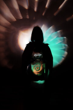 naked woman back with circle colorful neon lightening and glasses on her head, spiral sign