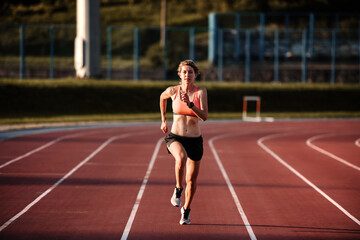 Athletic energetic woman running on athletic truck