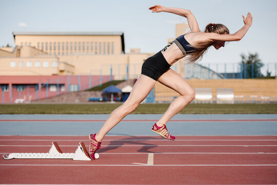 Sportswoman using starting block on start